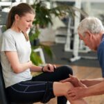 Fit young woman having knee pain at gym. How to help reduce the risk of personal injury during fitness training.